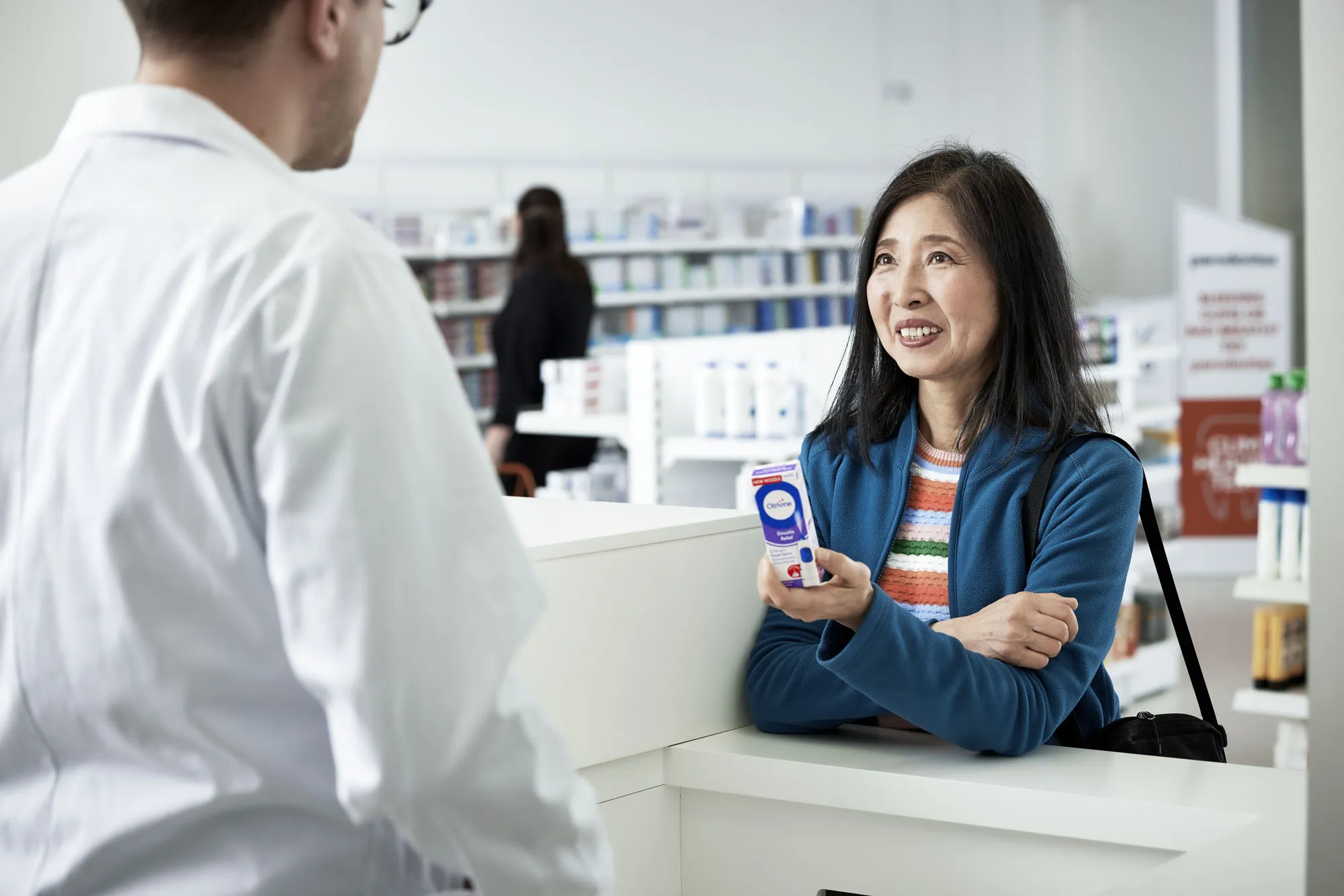 Customer purchasing Otrivine in a pharmacy
