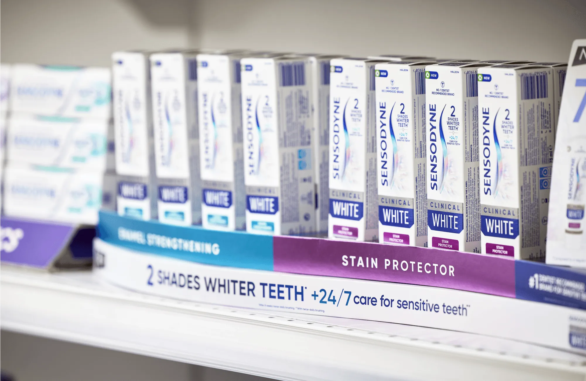 Row of Sensodyne Clinical White toothpastes on a shelf