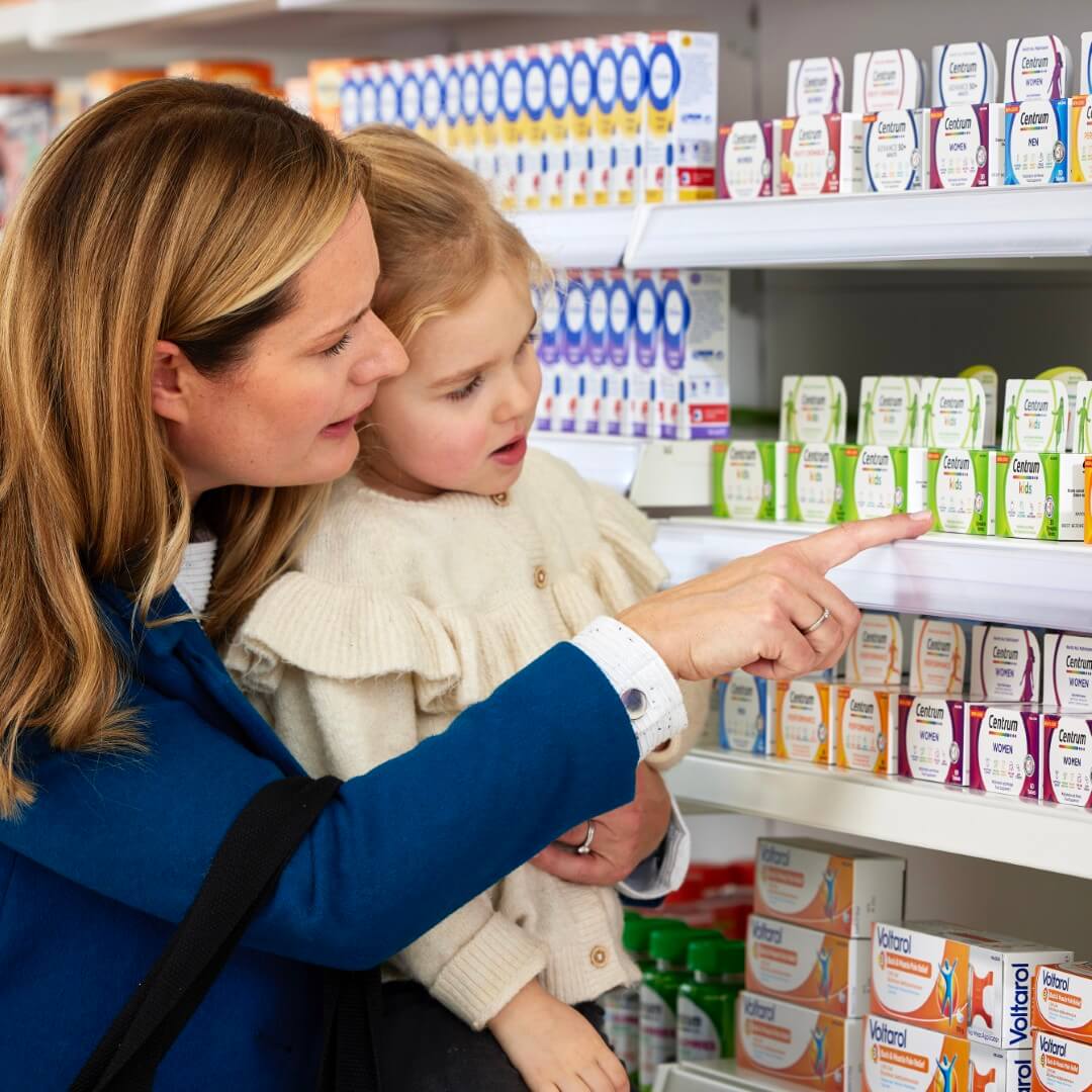 Woman showing child products in a pharmacy