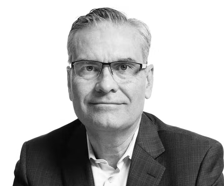 A headshot of Brian McNamara, the image is in black and white