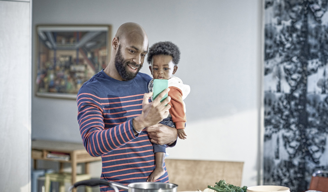 Father and son looking at mobile phone