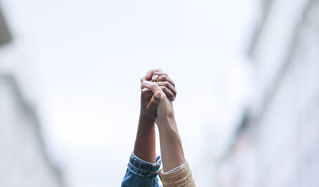 Two hands holding straight up