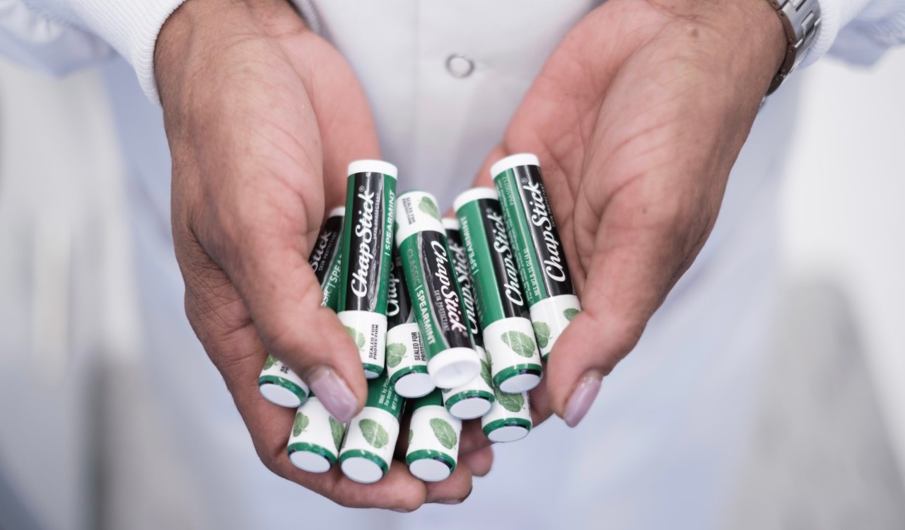 Hands holding Chapsticks