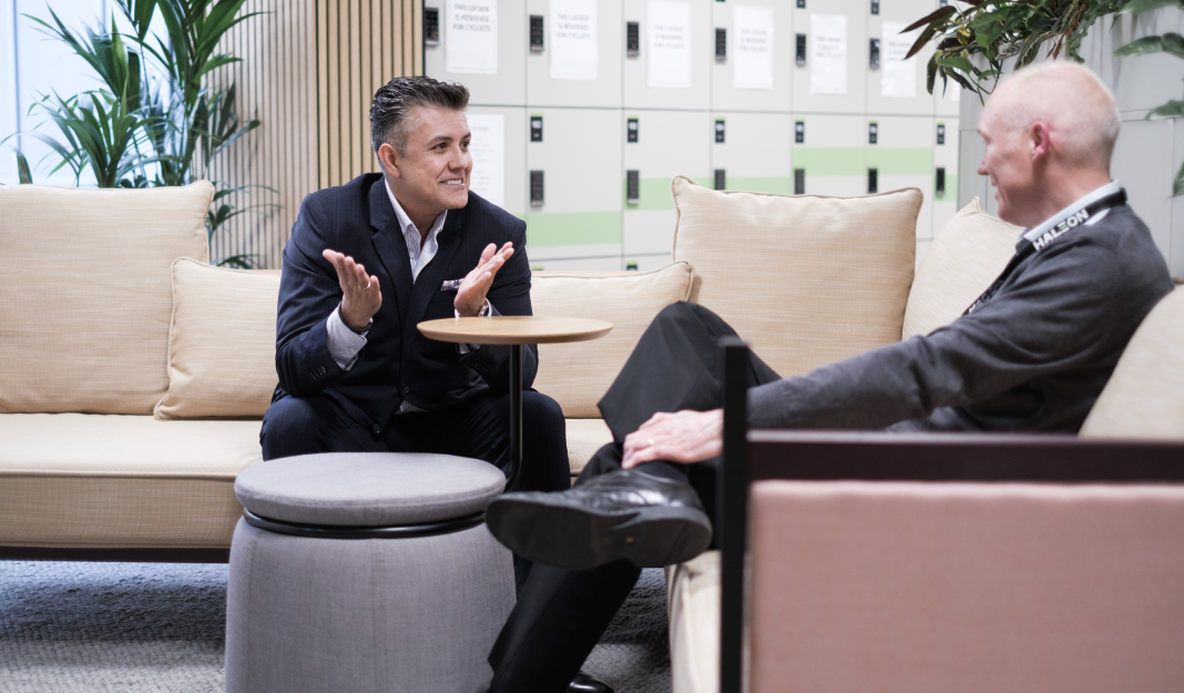 Two formally dressed men discussing with each other