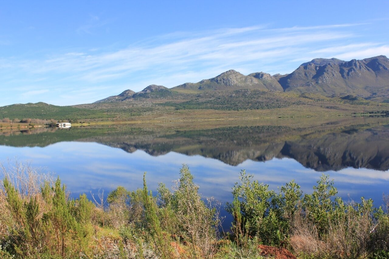 Landscape of green hills and a dam
