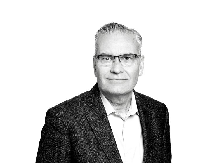 A headshot of Brian McNamara, the image is in black and white