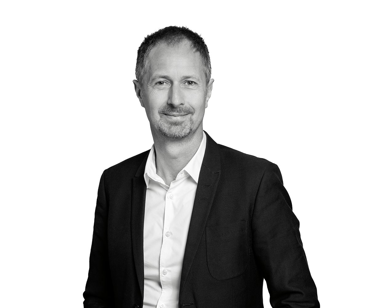 A headshot of Frank Riot, the image is in black and white